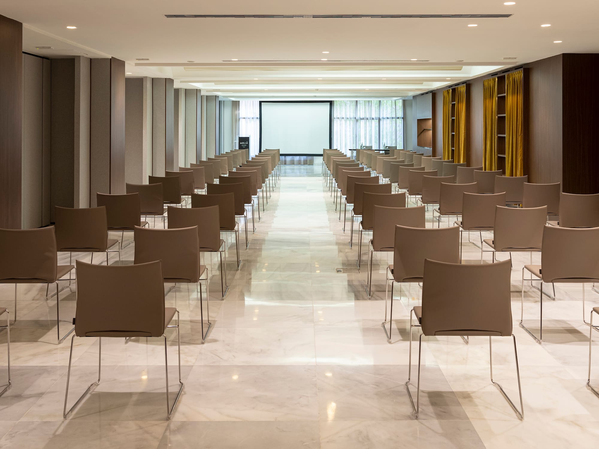 a room with chairs and a projector screen
