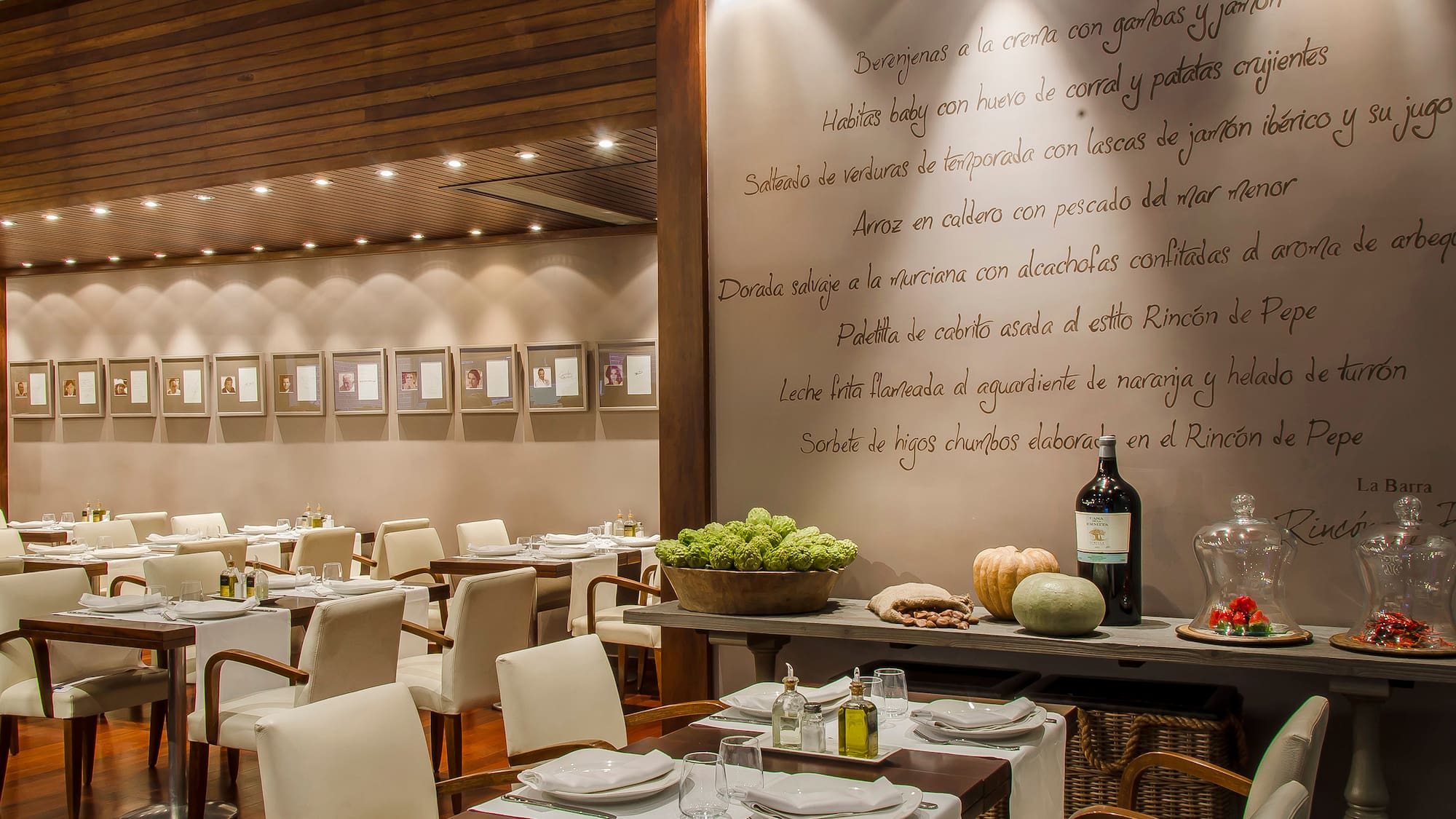 a restaurant with white chairs and tables