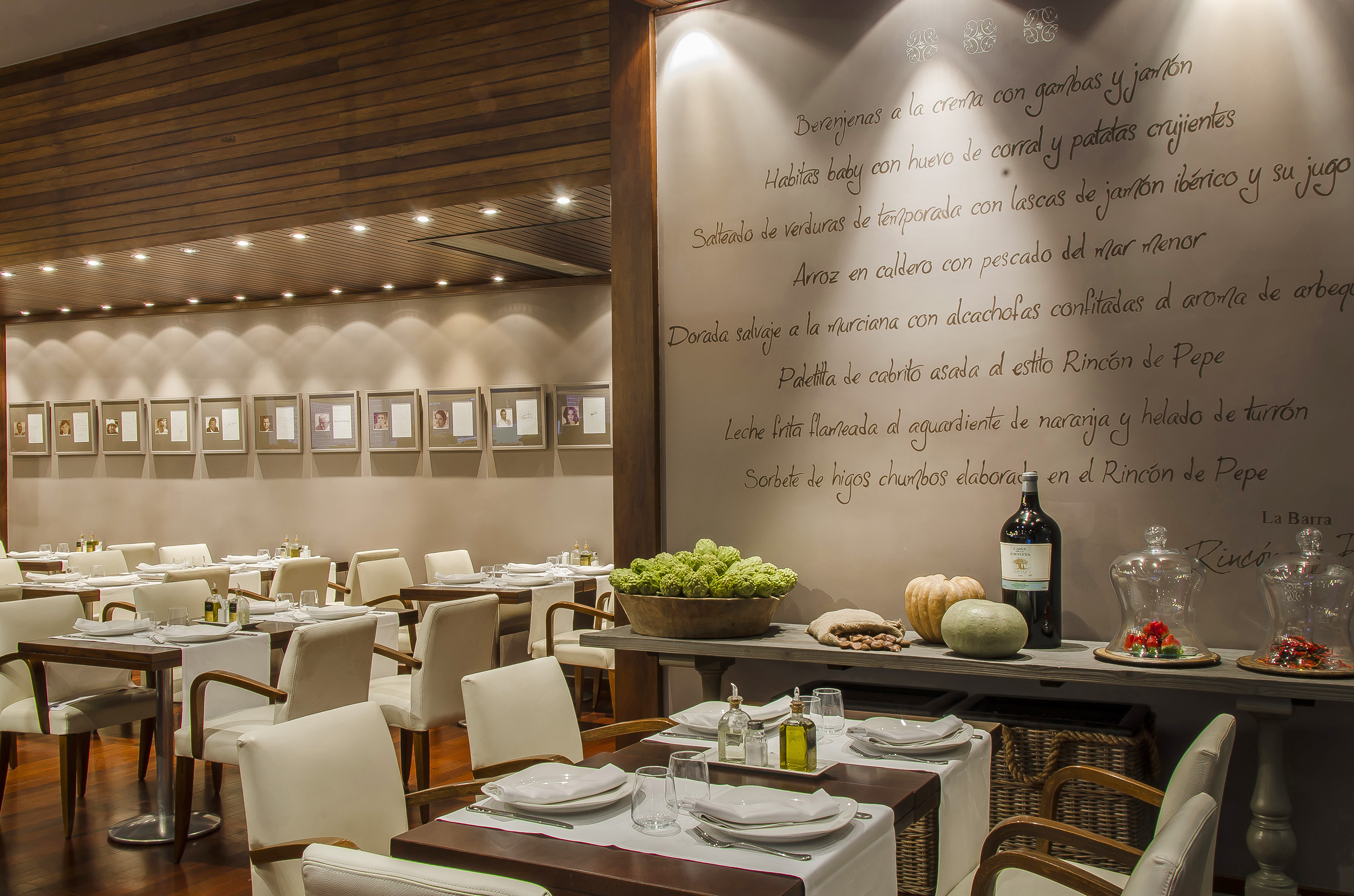 Elegant Rincón de Pepe restaurant dining room with Spanish menu wall.