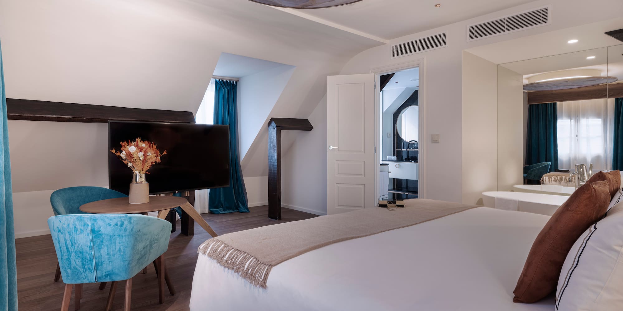 a room with a bed and a television