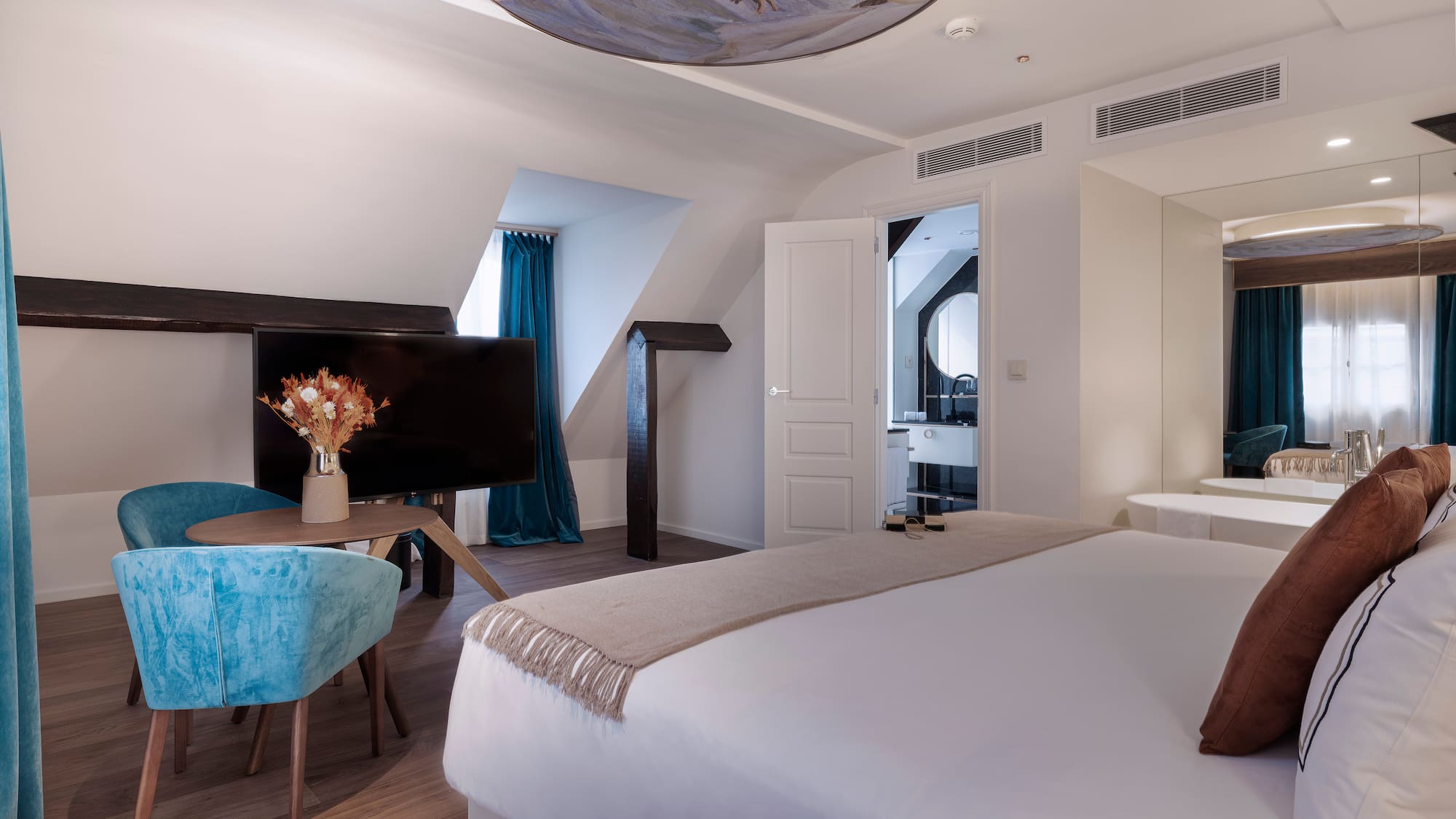 a room with a bed and a television