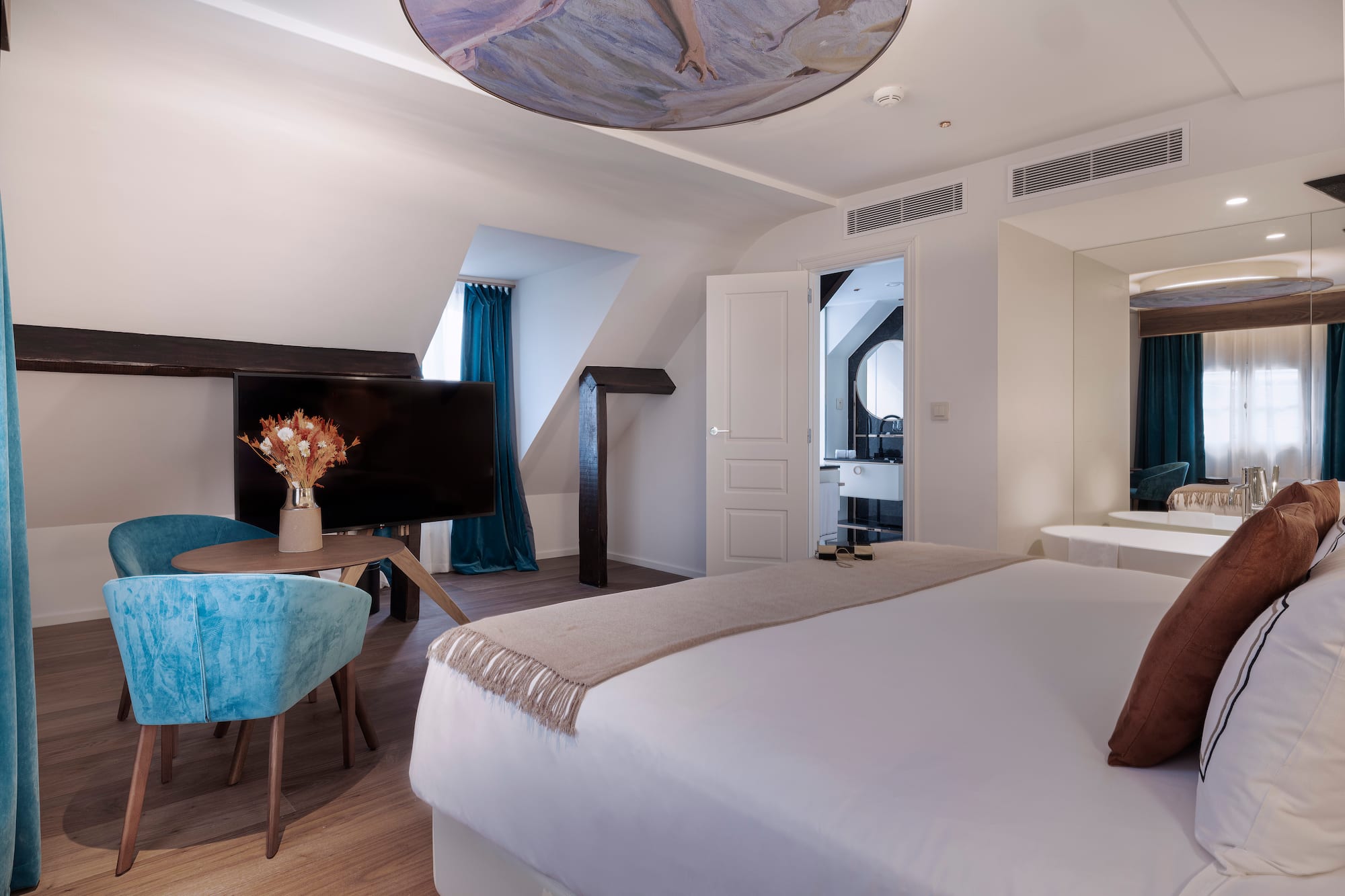 a room with a bed and a television