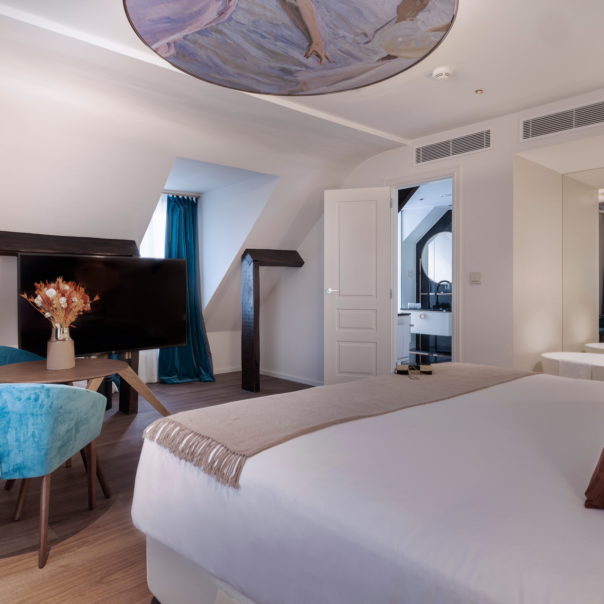 a room with a bed and a television