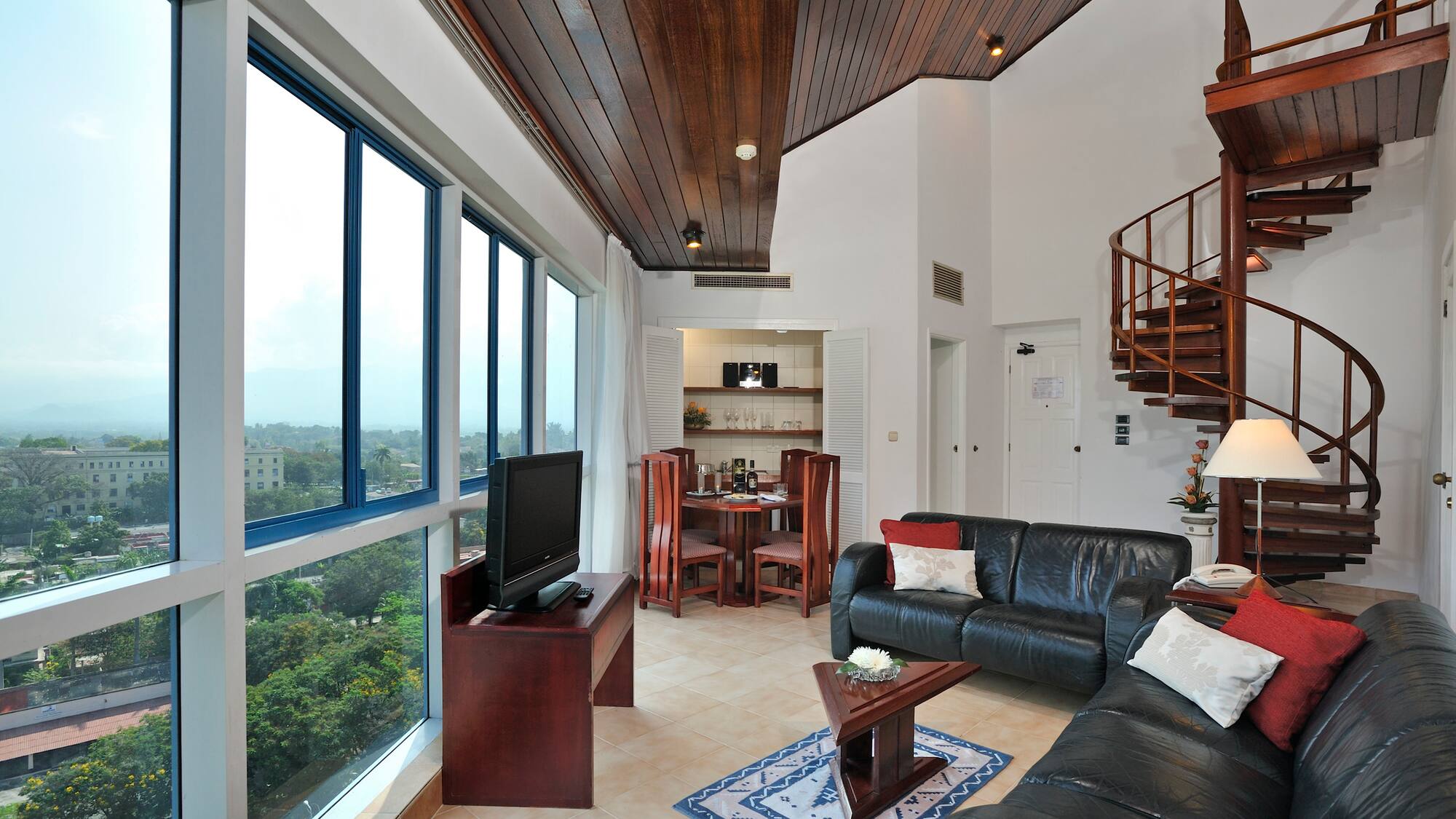 a living room with a spiral staircase and a couch