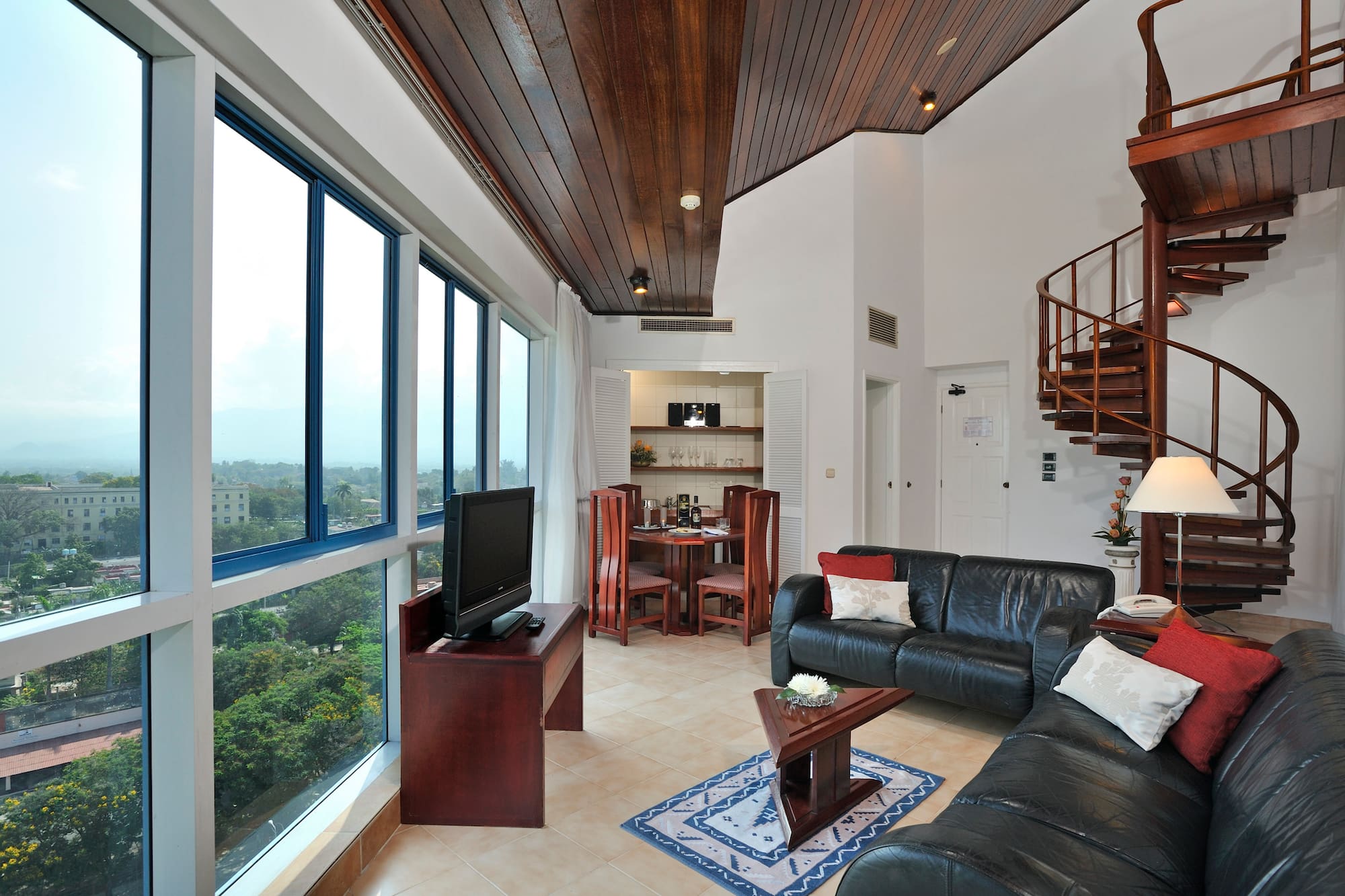 a living room with a spiral staircase and a couch