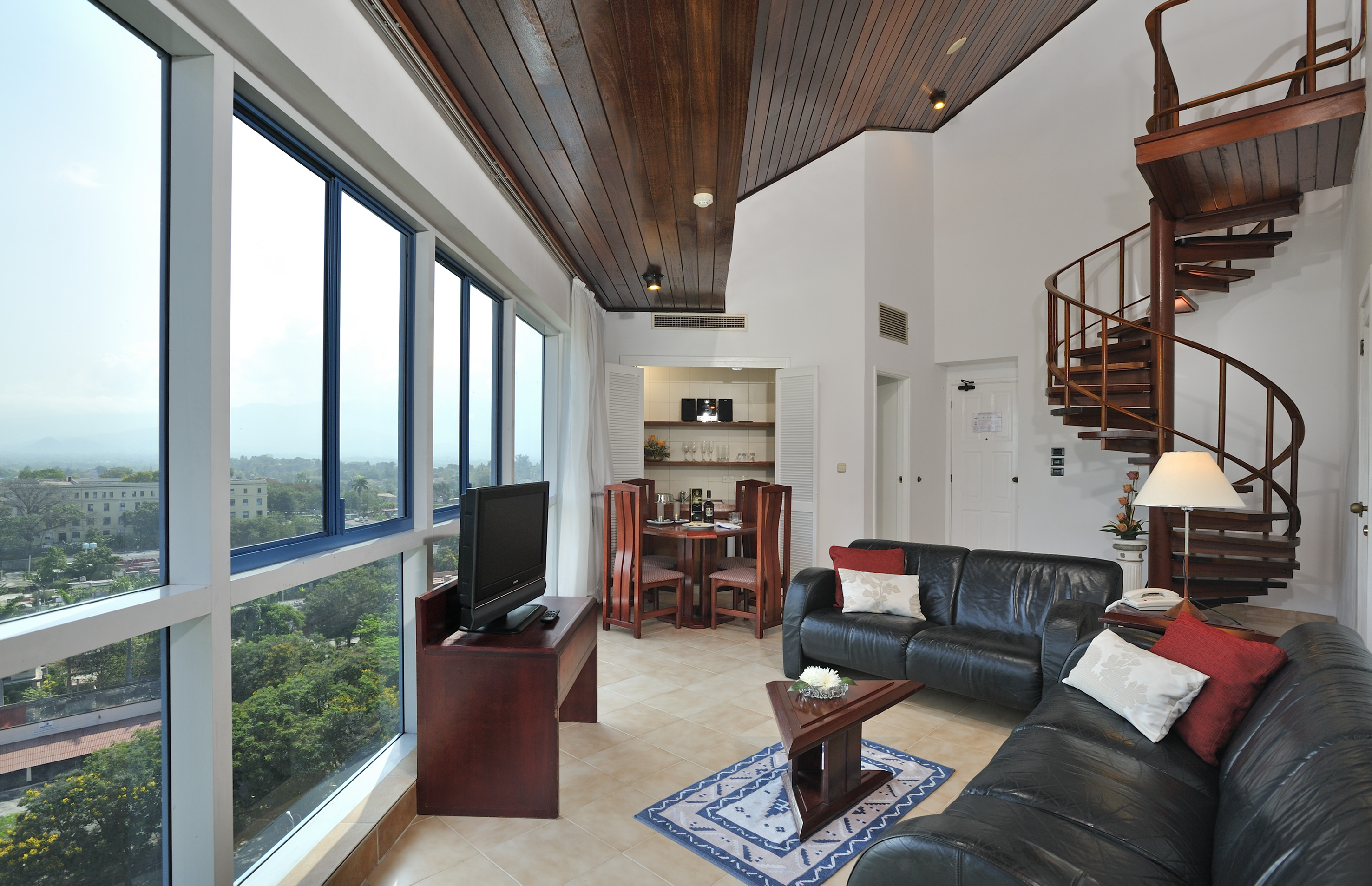 a living room with a spiral staircase and a couch