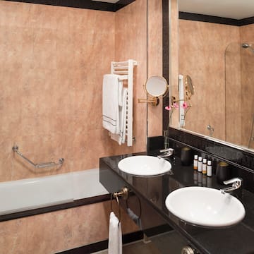 a bathroom with a black countertop and a black sink
