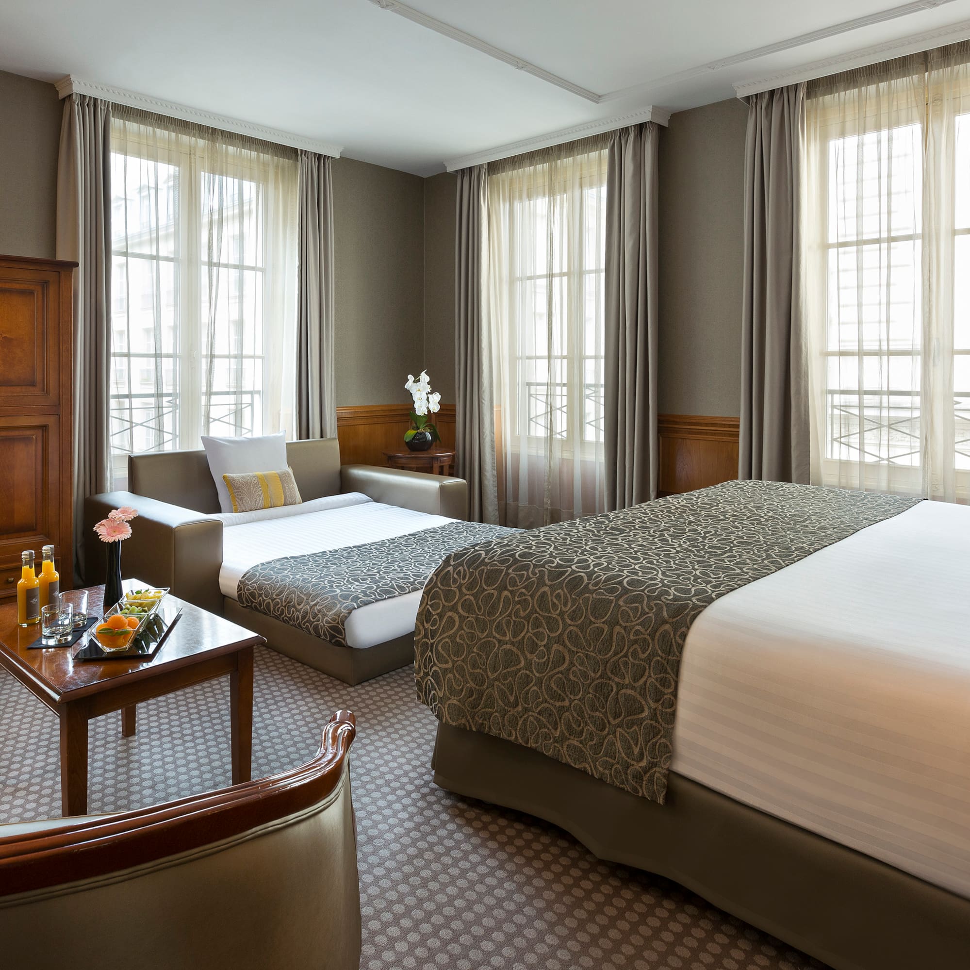 a room with two beds and a couch