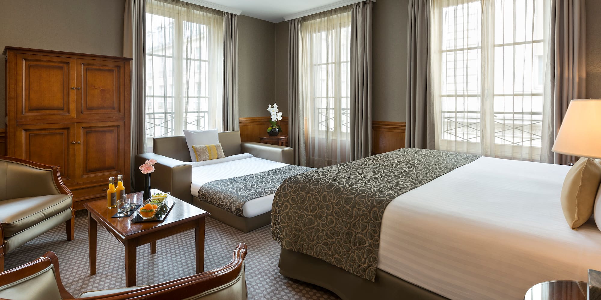 a room with two beds and a couch