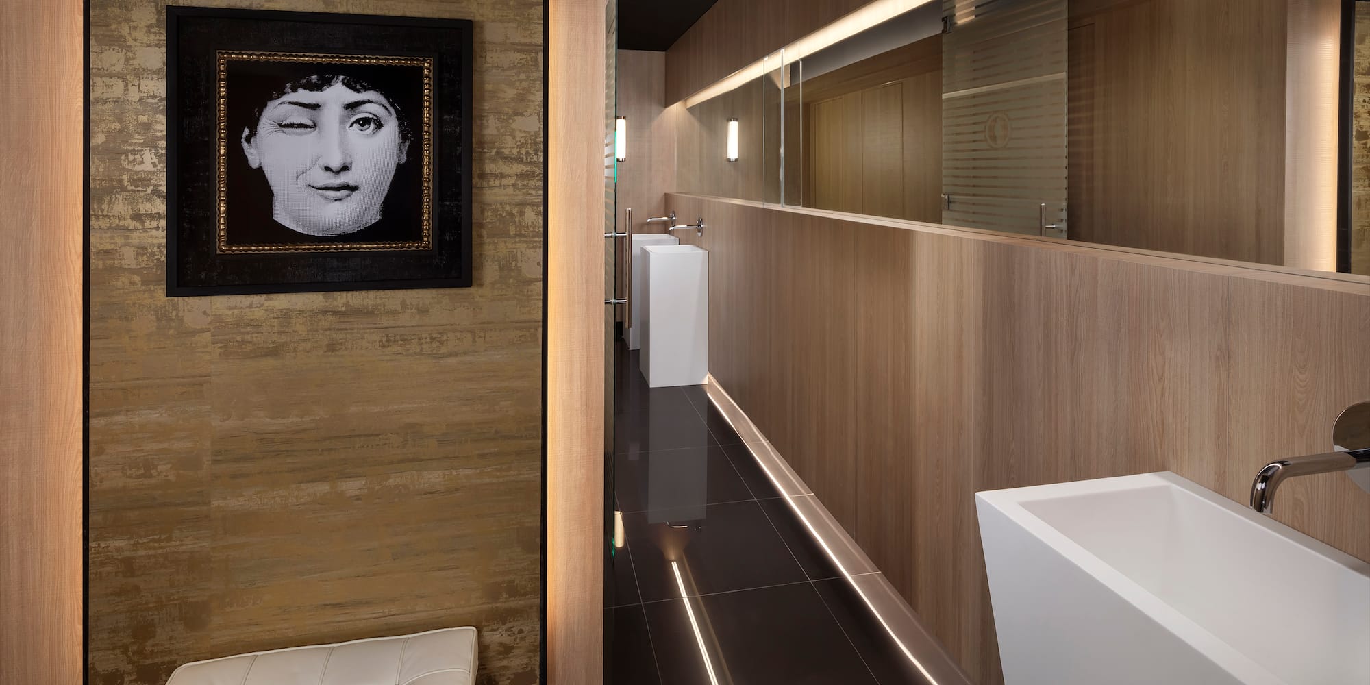 a bathroom with a black and white picture of a woman's face