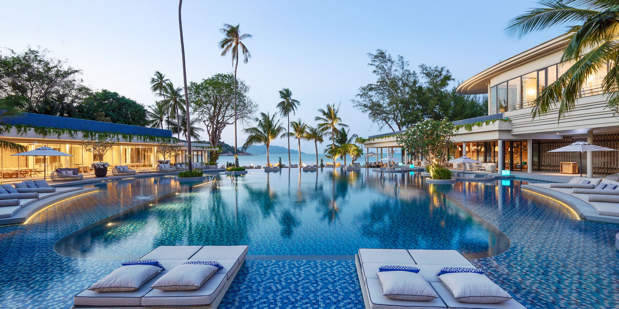 a pool with lounge chairs and palm trees