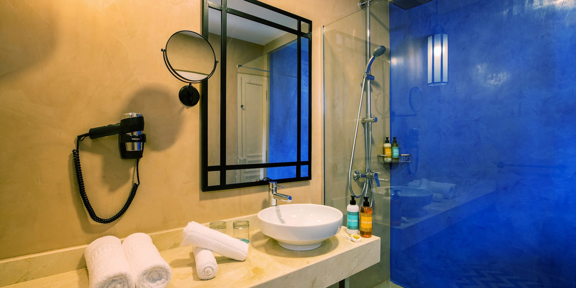 a bathroom with a blue shower and sink