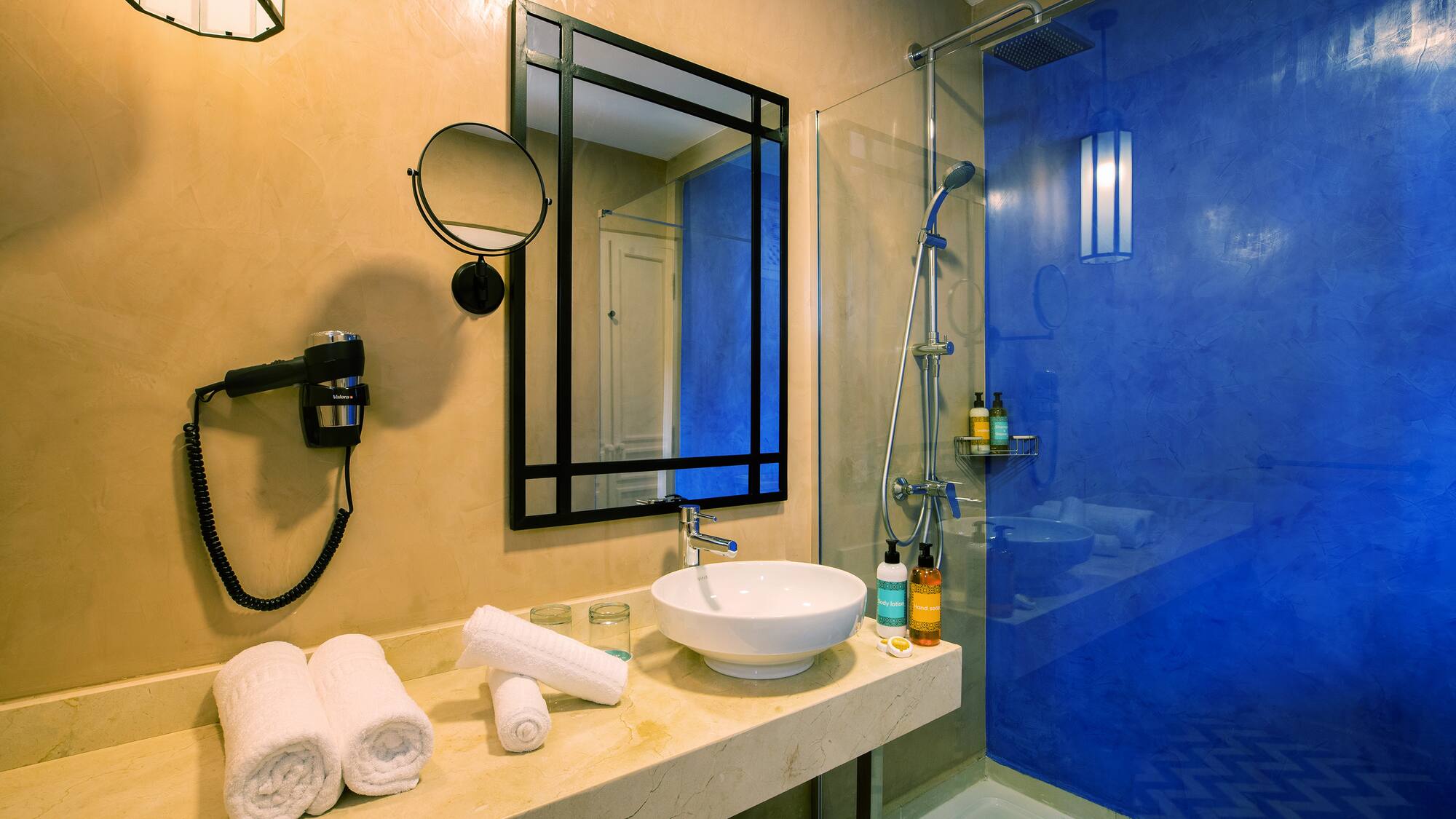 a bathroom with a blue shower and sink