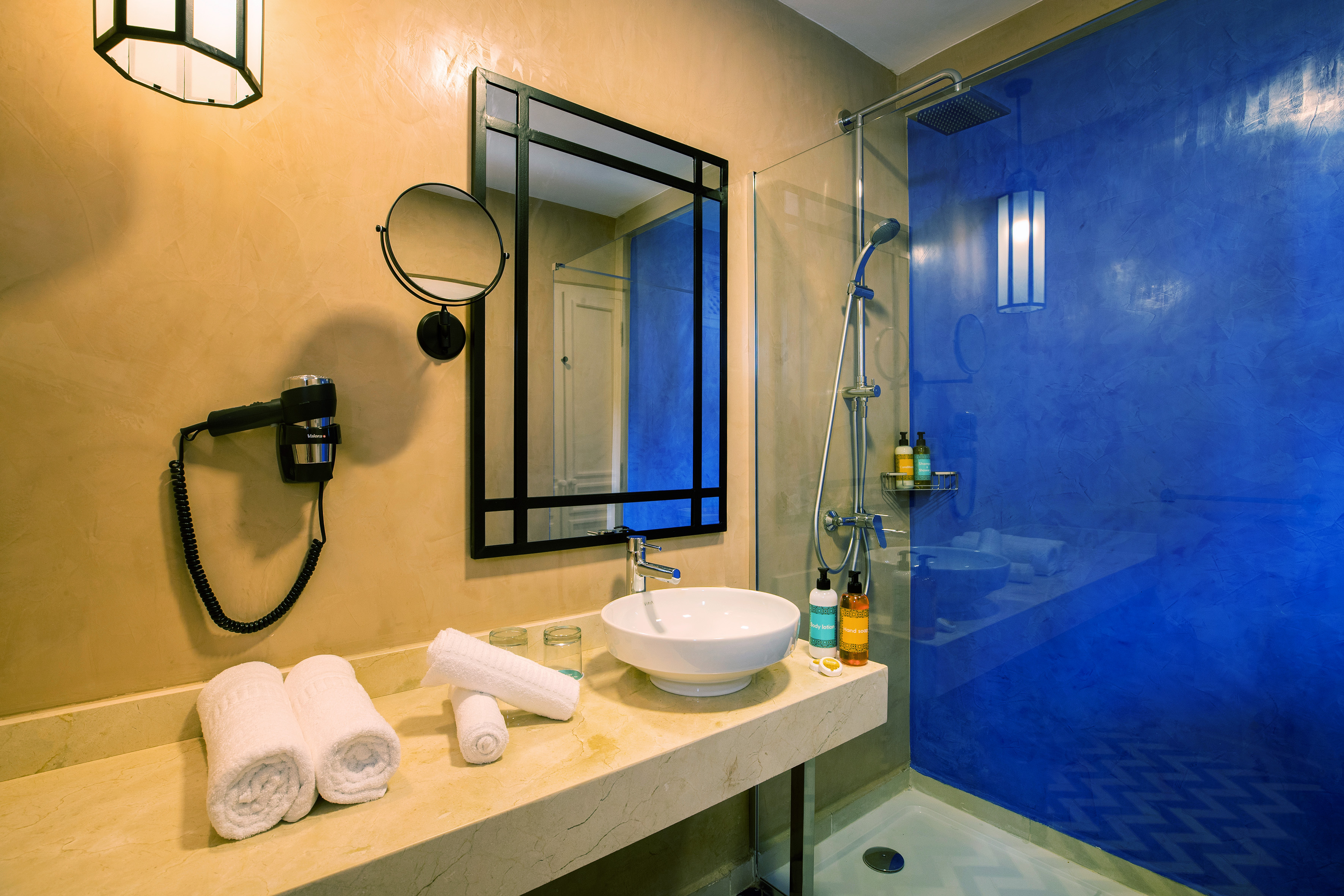 a bathroom with a blue shower and sink