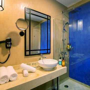 a bathroom with a blue shower and sink