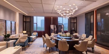 a room with a round table and chairs