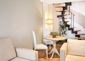 a room with a spiral staircase and a table and chairs