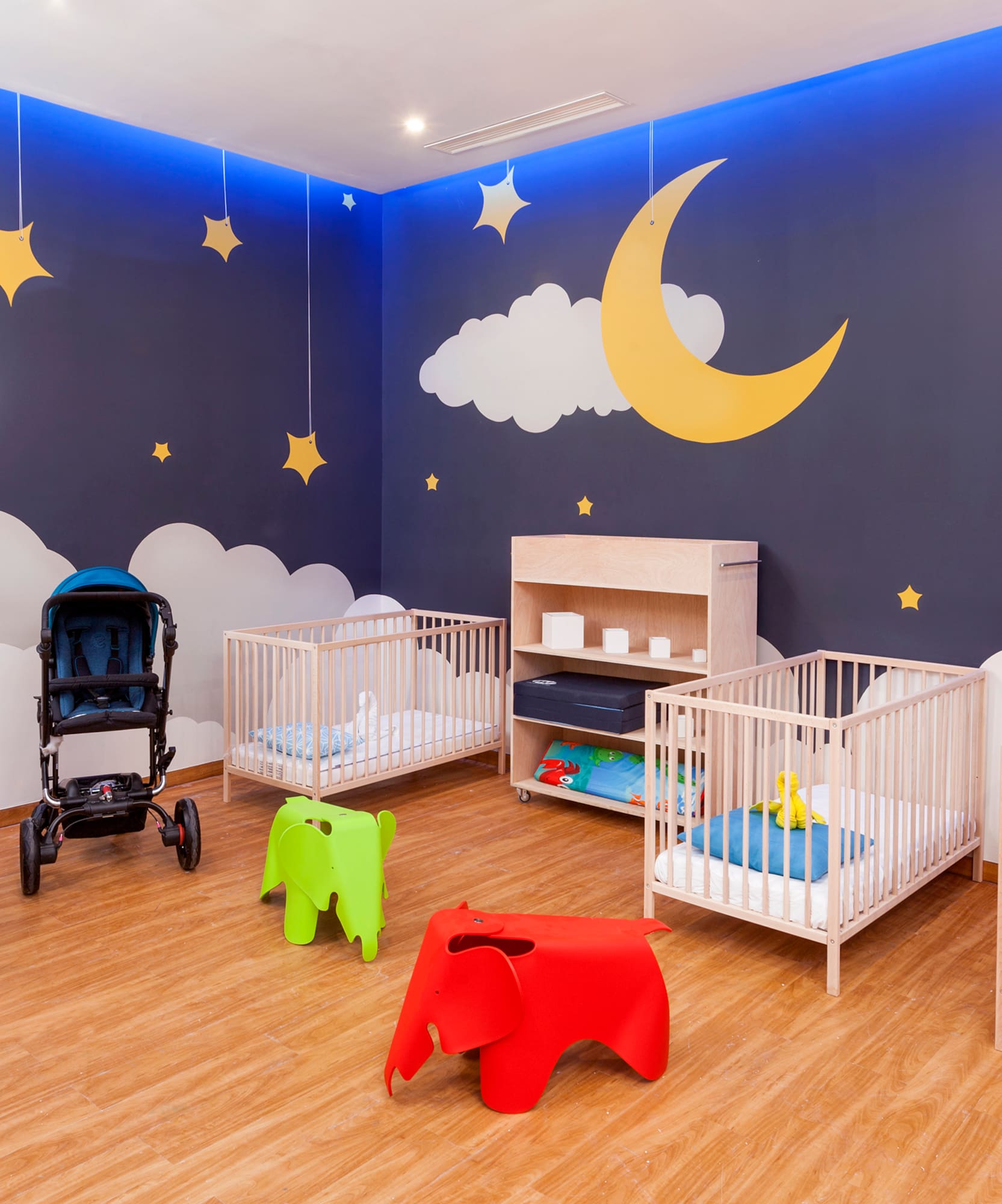 a room with cribs and baby strollers