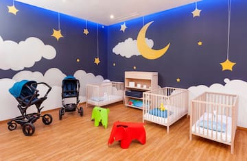 a room with cribs and baby strollers