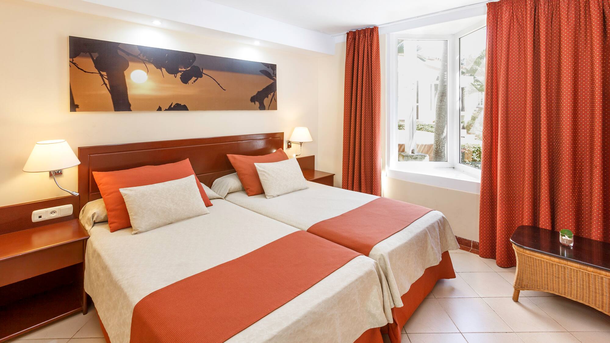 a room with two beds and a window