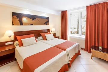 a room with two beds and a window