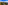 a tower on a hill with trees and a city in the background