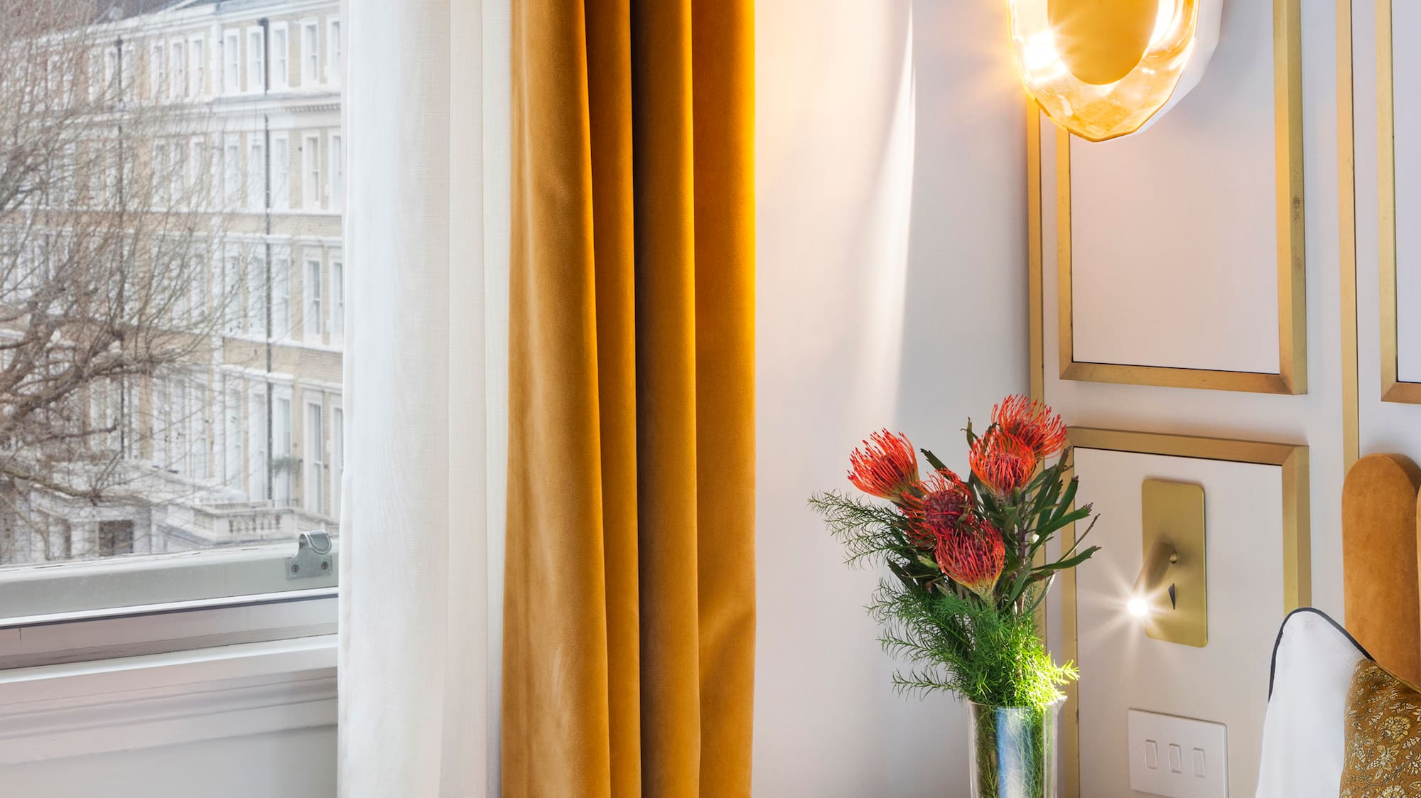 a vase of flowers on a table next to a window