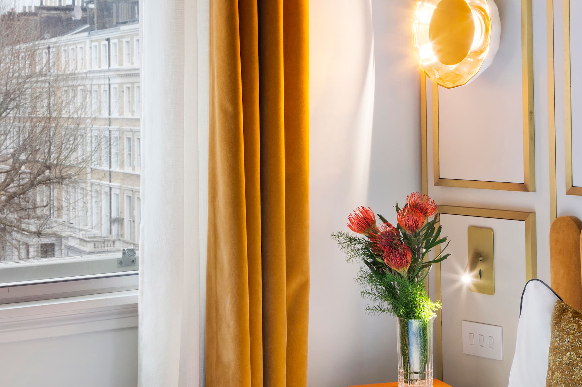 a vase of flowers on a table next to a window
