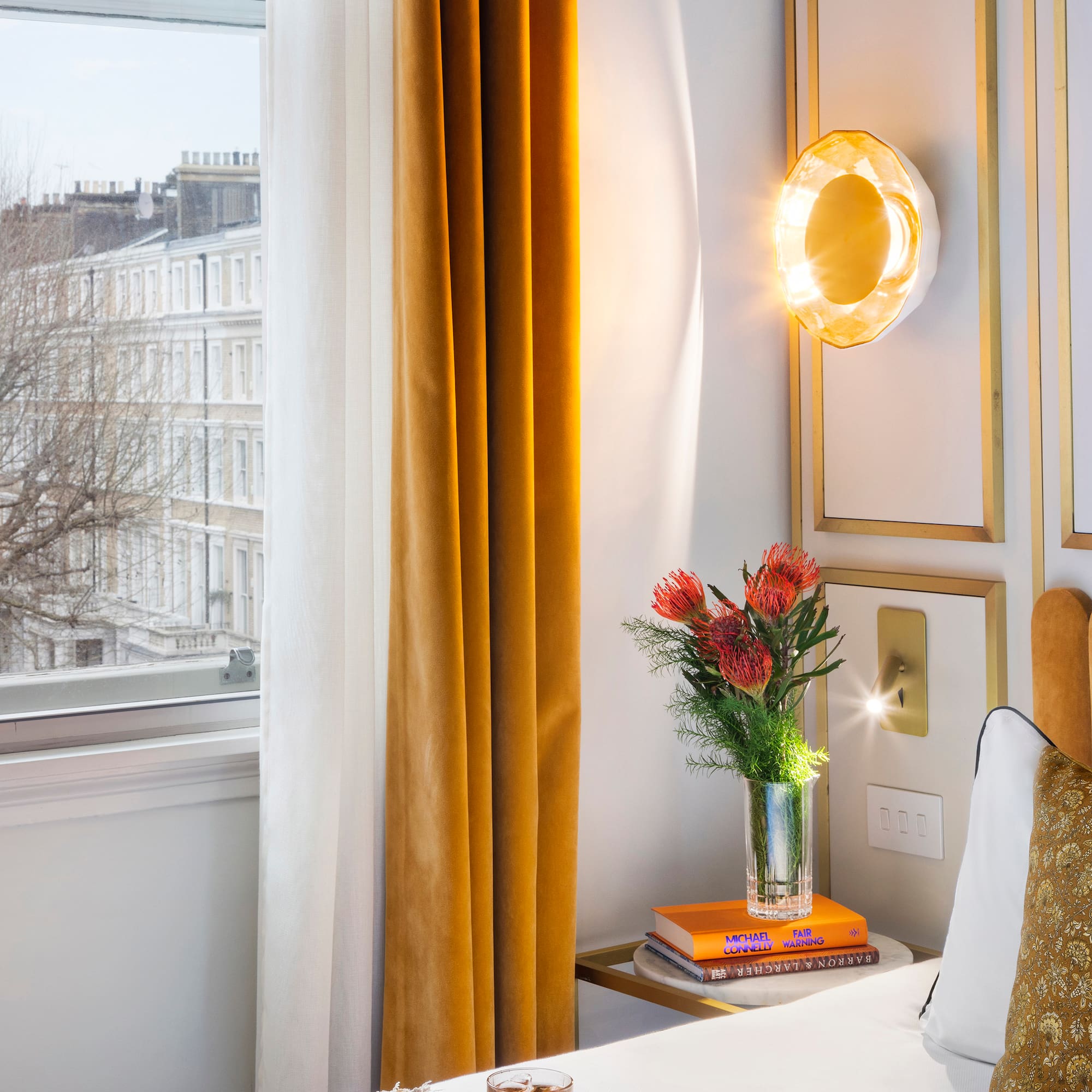 a vase of flowers on a table next to a window