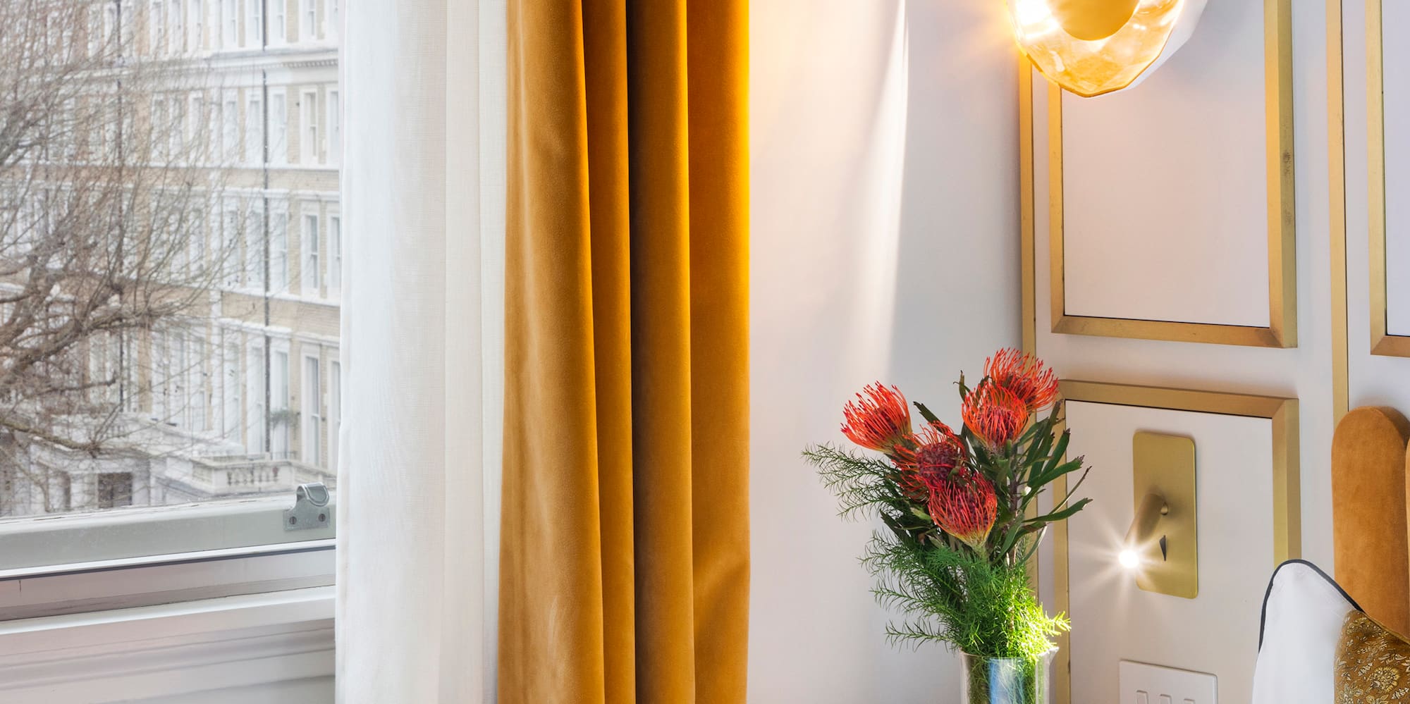 a vase of flowers on a table next to a window