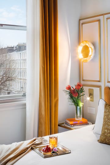 a vase of flowers on a table next to a window