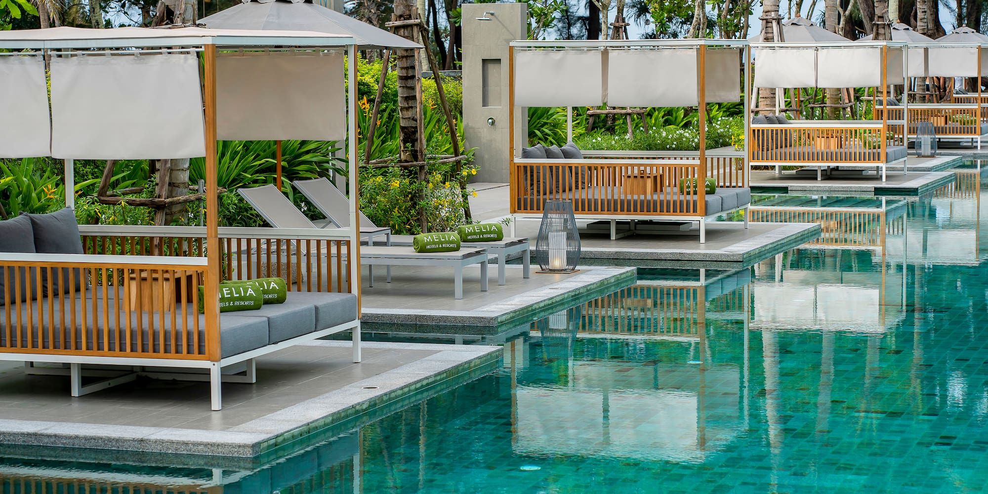 a pool with lounge chairs and umbrellas