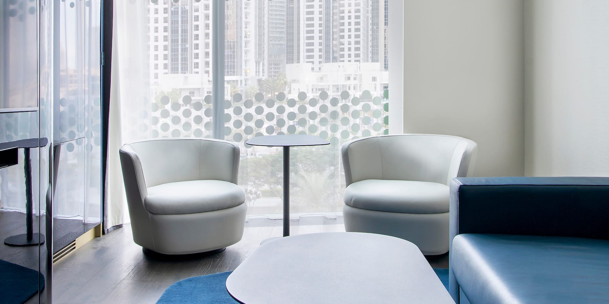 a room with white chairs and a table