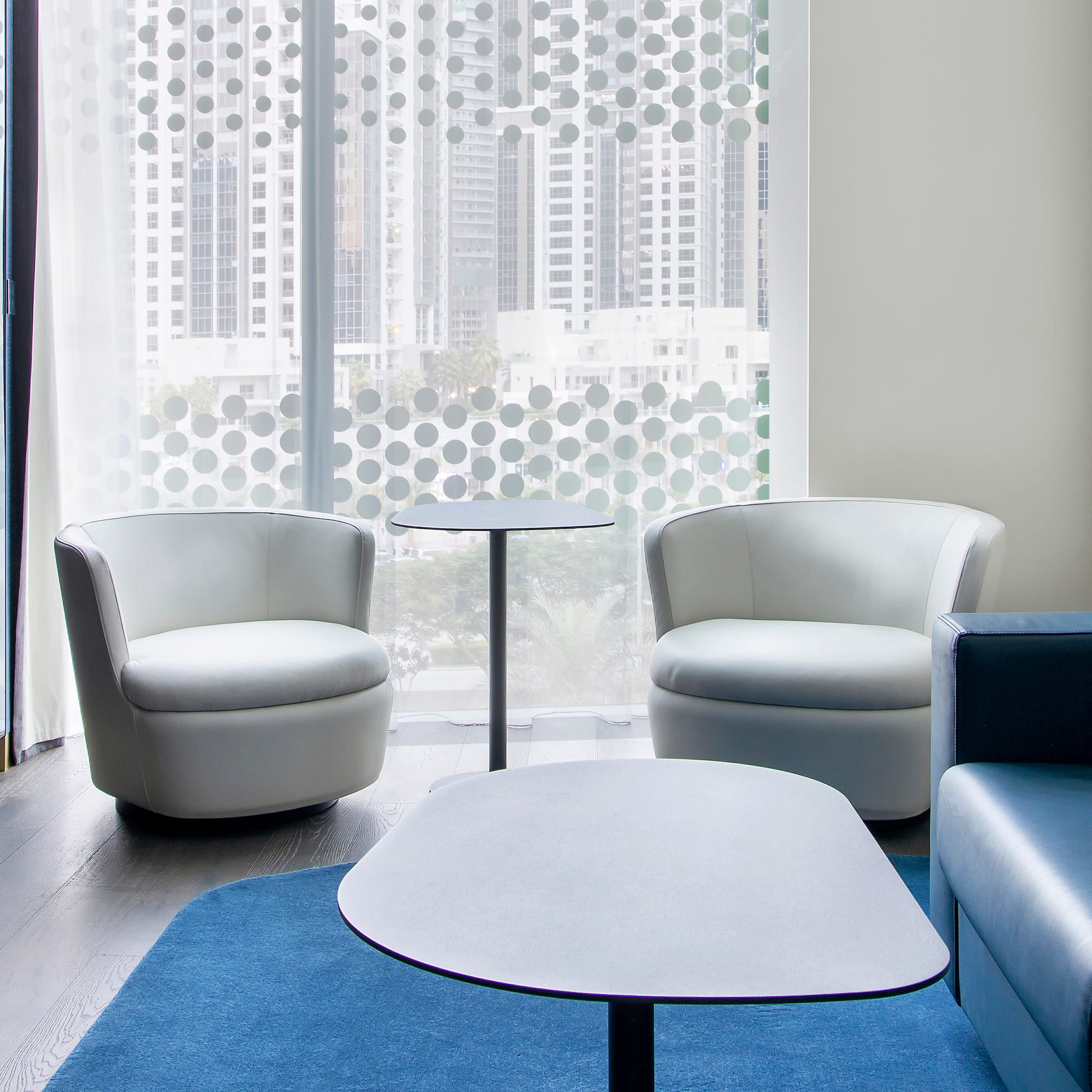 a room with white chairs and a table