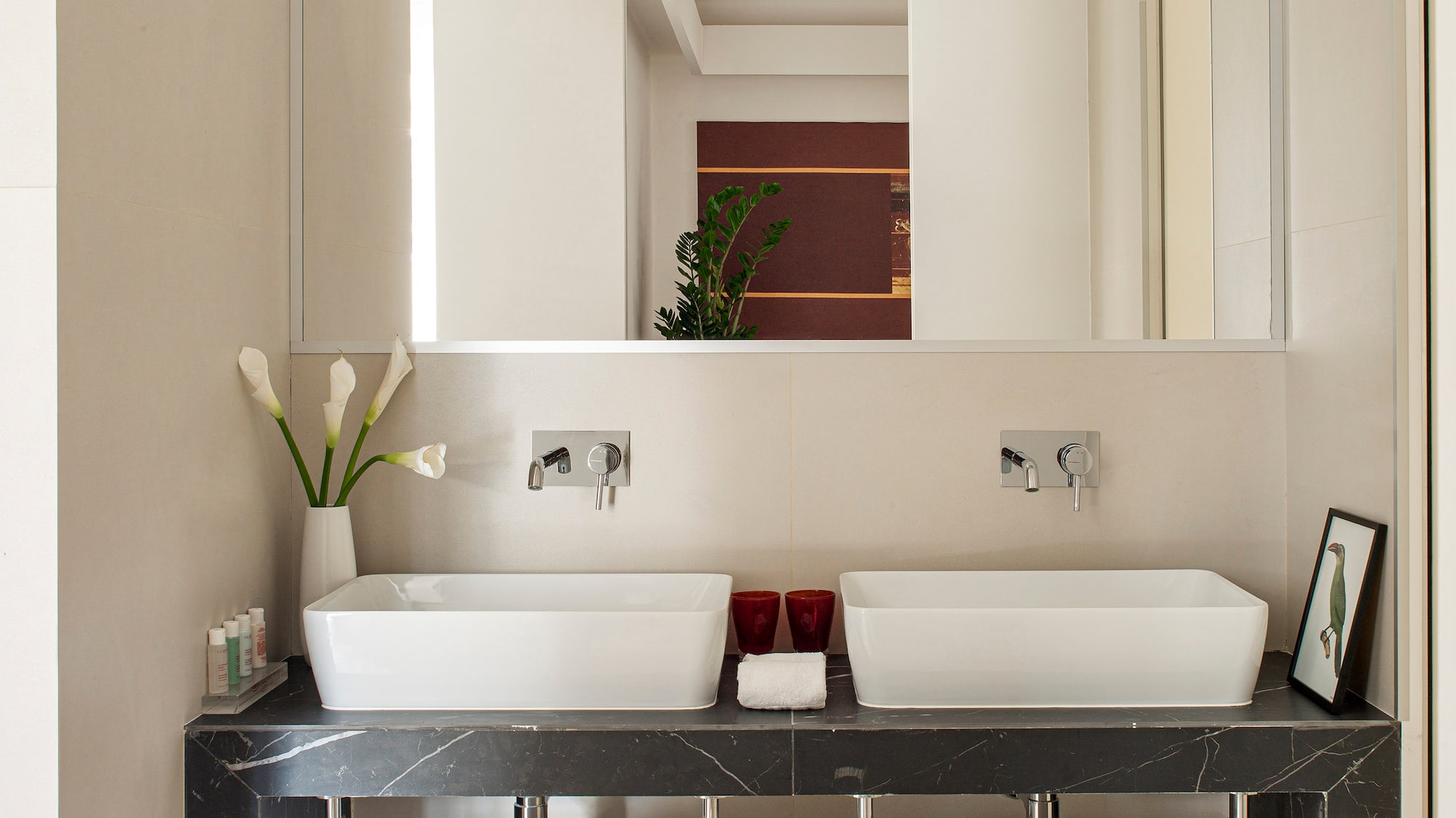 a bathroom with two sinks and a mirror