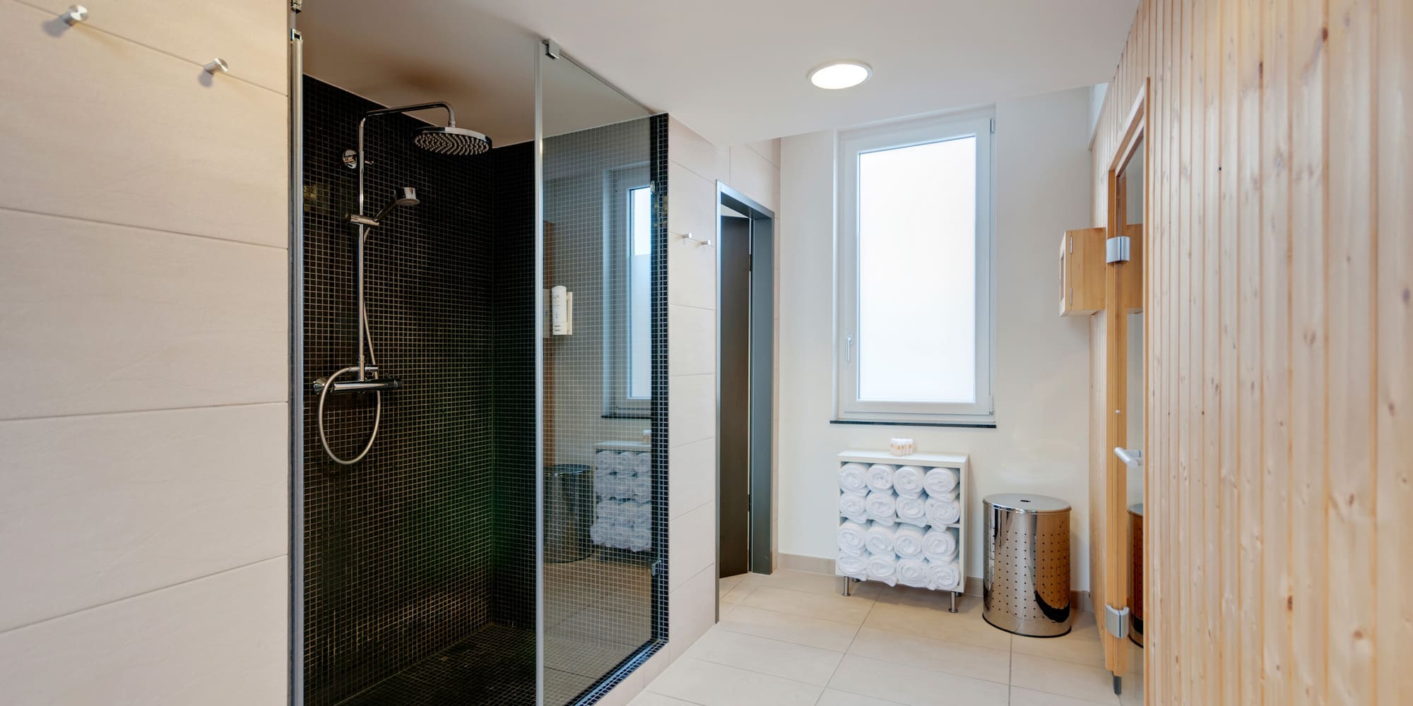a bathroom with a shower and a window