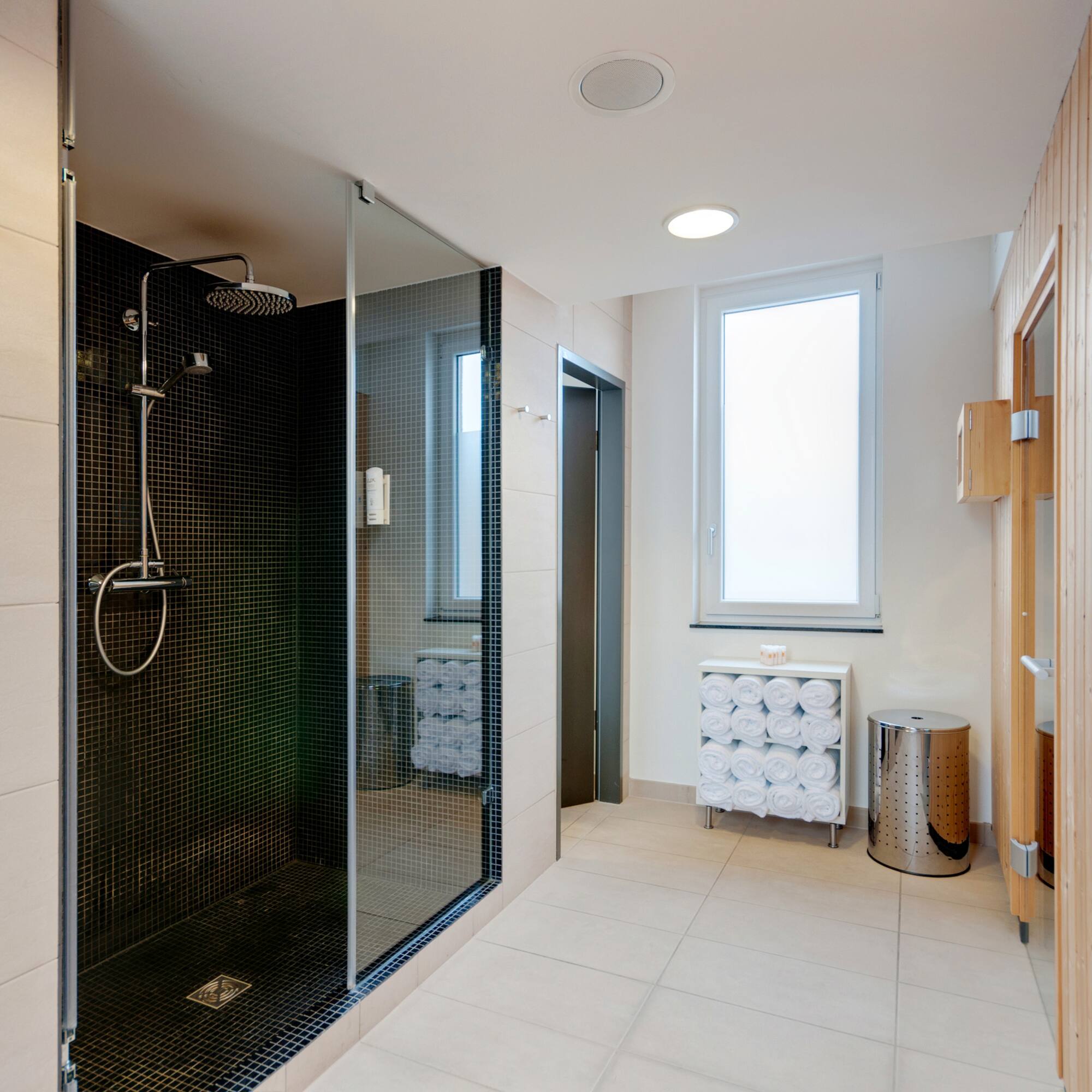 a bathroom with a shower and a window