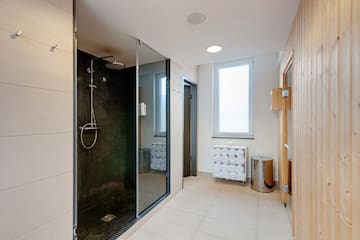 a bathroom with a shower and a window