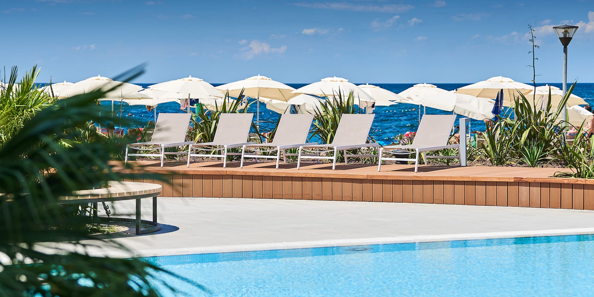 a pool with chairs and umbrellas