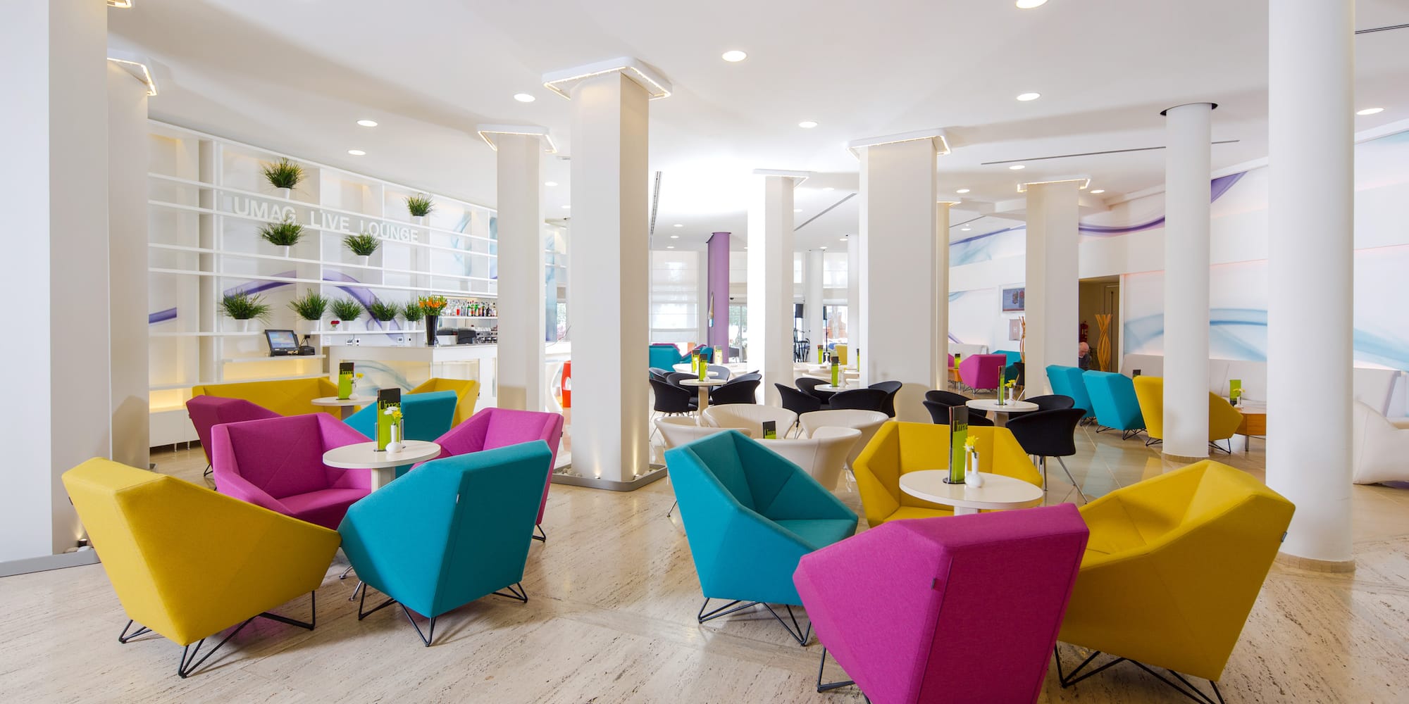 a room with colorful chairs and tables