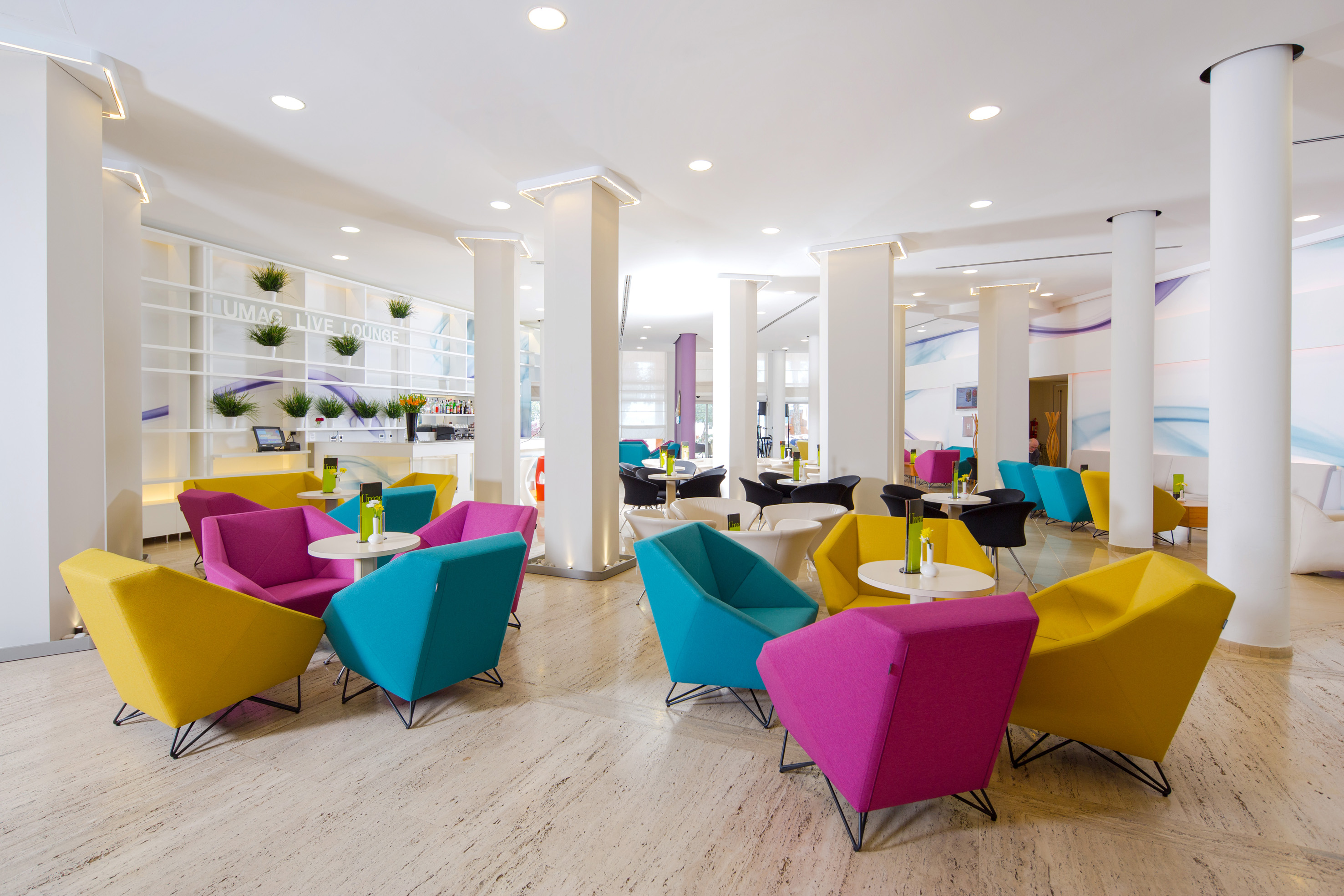 a room with colorful chairs and tables