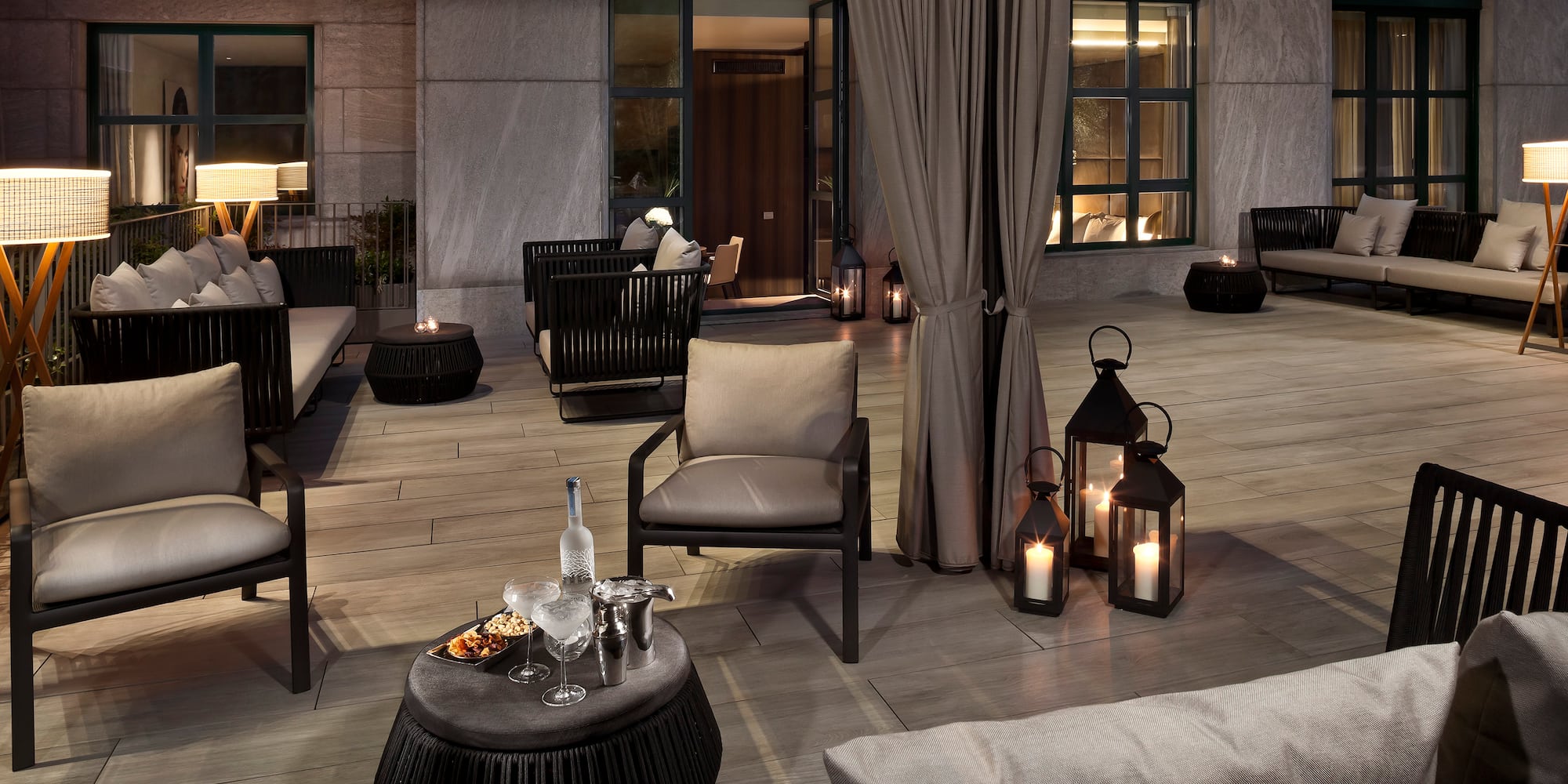 a patio with chairs and tables and candles