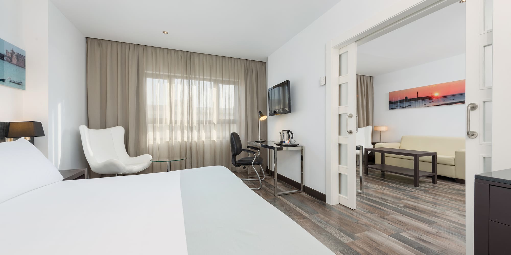 a room with a bed and a desk and chair