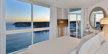 a bedroom with a view of the ocean and a window