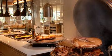 a large group of meat on a grill