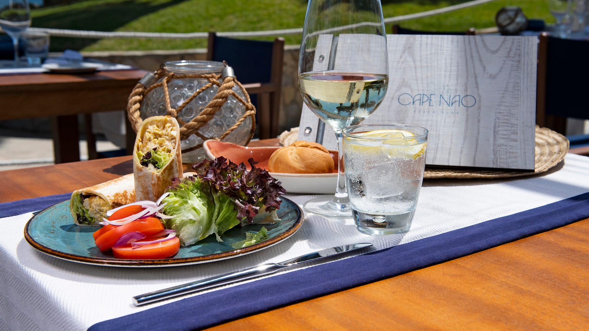 a plate of food and a glass of water on a table