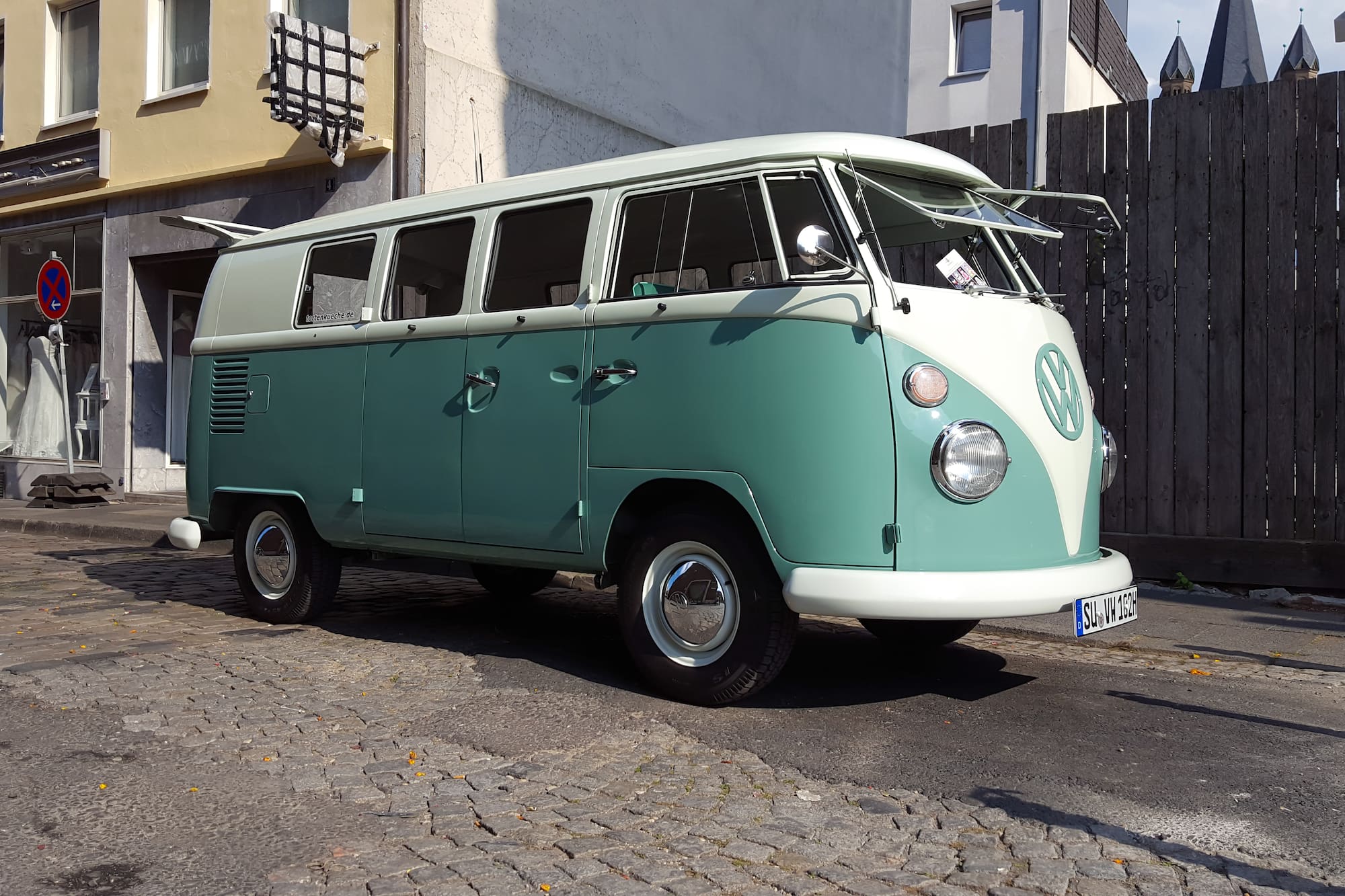 a green and white van parked on a street
