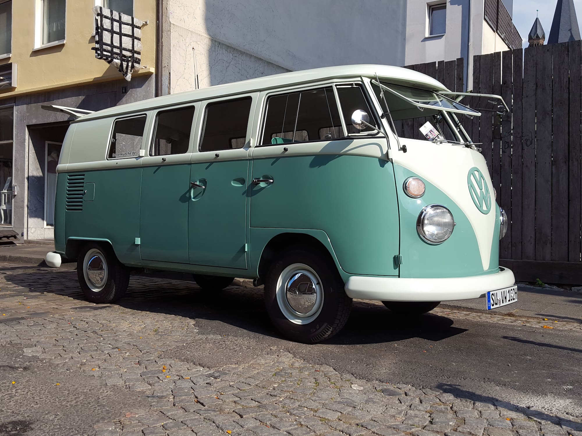 a green and white van parked on a street