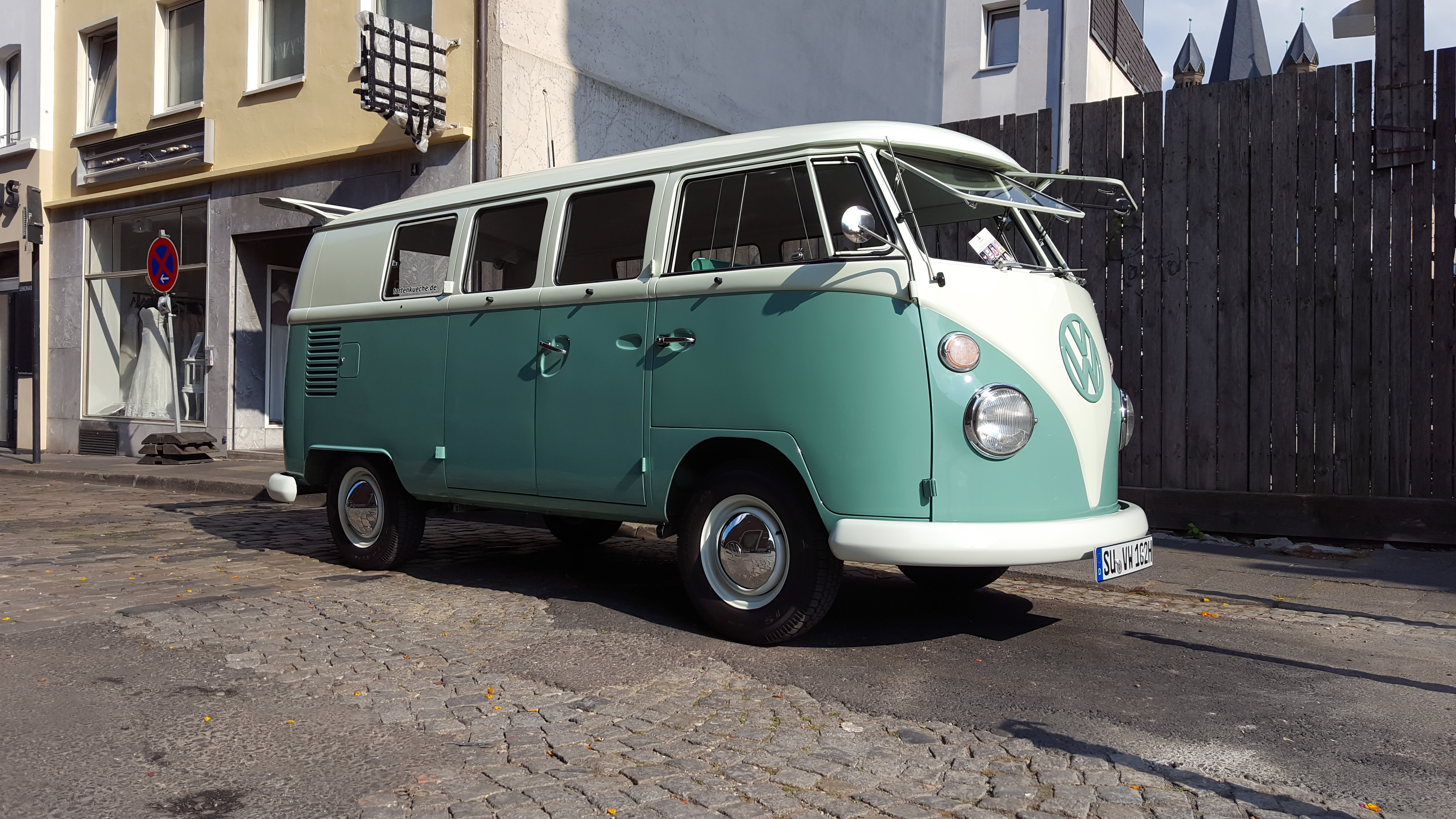a green and white van parked on a street