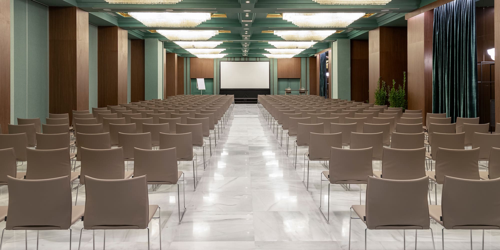 a room with chairs and a projector screen